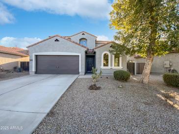 Two-story house with a two-car garage and desert landscaping at 37855 W Merced St, Maricopa, AZ 85138