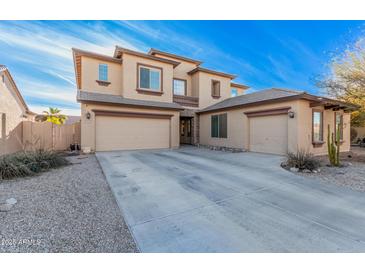 Two-story house with three-car garage, desert landscaping, and light-colored exterior at 18147 W Desert View Ln, Goodyear, AZ 85338