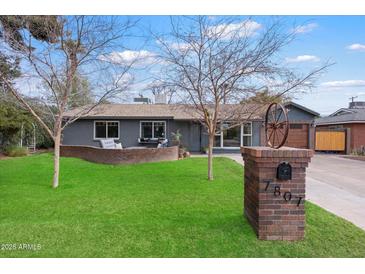 Charming home featuring a well-manicured lawn and brick mailbox with decorative wheel at 7807 N 17Th Dr, Phoenix, AZ 85021