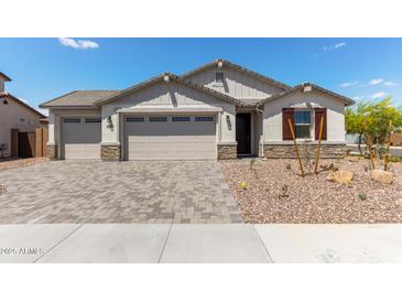 Charming single-story home with a three-car garage, desert landscaping, and a welcoming facade at 12358 W Marguerite Ave, Avondale, AZ 85323