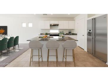 Modern kitchen with island, stainless steel appliances, and granite countertops at 1337 W Inca Dr, Coolidge, AZ 85128