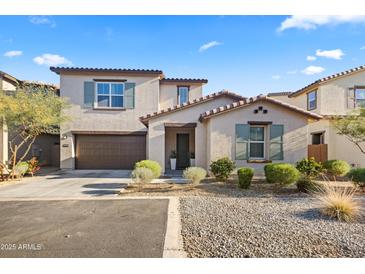 Two-story home with brown garage door and landscaping at 17755 W Jojoba Rd, Goodyear, AZ 85338