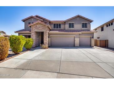 Two-story house with stone accents and a three-car garage at 225 N 236Th Ave, Buckeye, AZ 85396