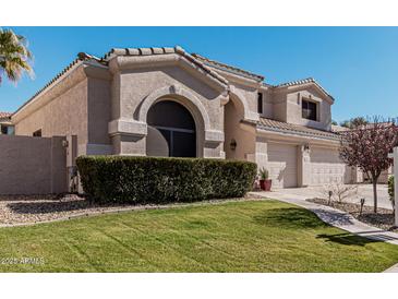 Two-story house with a three-car garage and manicured lawn at 3331 S Vine St, Chandler, AZ 85248