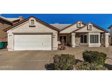 One-story house with a two-car garage and well-maintained landscaping at 6632 E Fairbrook Cir, Mesa, AZ 85205