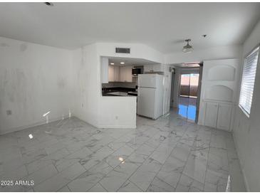 Bright kitchen features white cabinets, dark countertops, and modern appliances at 12221 W Bell Rd # 363, Surprise, AZ 85378