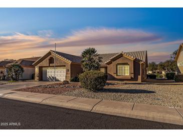 Single-story home with attached garage and landscaped front yard at 15220 W Blue Verde Dr, Sun City West, AZ 85375