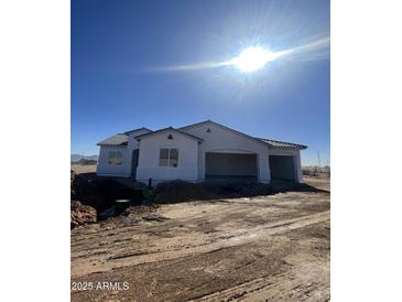 New construction home with a two-car garage and desert landscaping at 25505 W Brookhart Way, Wittmann, AZ 85361