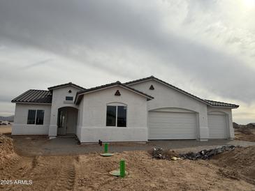 Charming single-story home featuring a stucco exterior, tile roof, and a three-car garage at 25505 W Brookhart Way, Wittmann, AZ 85361