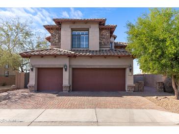 Charming two-story home with a tiled roof, stone accents, a brick driveway, and a two-car garage at 2742 N Augustine --, Mesa, AZ 85207