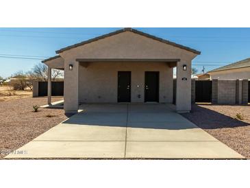 Close-up of a home's double carport featuring two dark doors and modern outdoor lighting fixtures at 3205 W Sueno Dr, Eloy, AZ 85131