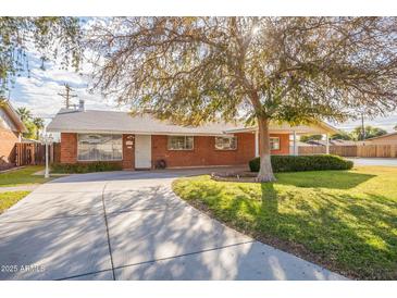 Brick ranch home with a large yard and driveway at 3249 W Maryland Ave, Phoenix, AZ 85017