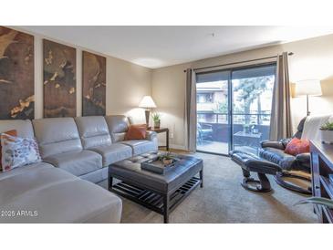 Bright living room with comfy seating and access to a private balcony at 4704 E Paradise Village N Pkwy # 239, Phoenix, AZ 85032