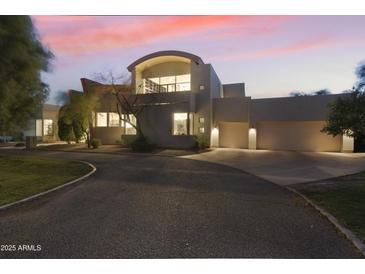 Luxury home with three-car garage, at dusk at 5301 E Calle Del Norte --, Phoenix, AZ 85018