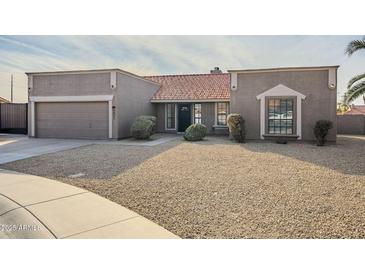 Single-story home with a two-car garage and desert landscaping at 5821 W Kesler St, Chandler, AZ 85226