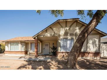 Attractive single-story home with brick facade and covered entryway at 8520 W Palm Ln # 1049, Phoenix, AZ 85037