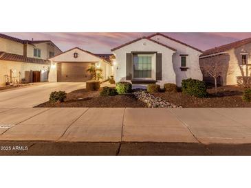 Single-story home with attached garage, landscaping, and a charming front entrance at 10496 W Cottontail Ln, Peoria, AZ 85383