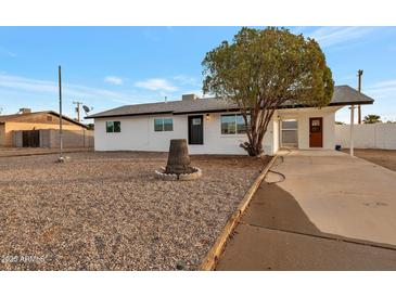 Charming single story home with a well-manicured front yard at 11411 E Crescent Ave, Mesa, AZ 85208