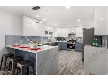 Modern kitchen with stainless steel appliances and an island at 1152 W Greenway Dr, Tempe, AZ 85282