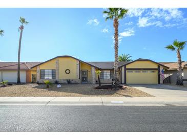 Single story home with desert landscaping and two-car garage at 12323 W Tigerseye Dr, Sun City West, AZ 85375