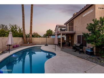 Inviting kidney-shaped pool with patio and grilling area at 1540 W Orchid Ln, Chandler, AZ 85224