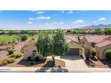 Single-story home with desert landscaping, two-car garage, and mountain views at 20515 N 264Th Ave, Buckeye, AZ 85396