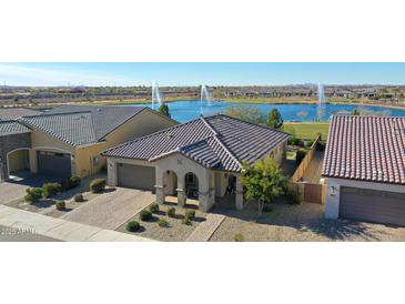 Aerial view of a house near lake with fountains at 24454 N 173Rd Ln, Surprise, AZ 85387