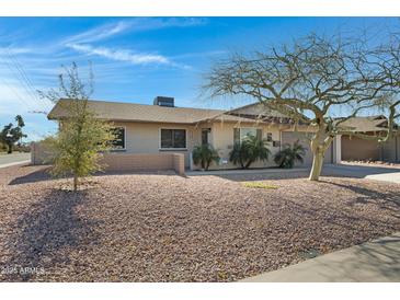 House exterior featuring a well-maintained lawn and a two-car garage at 2543 E Manhatton Dr, Tempe, AZ 85282