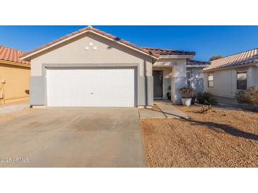 House exterior features a white garage door, landscaping, and a paved driveway at 2602 W Roeser Rd, Phoenix, AZ 85041