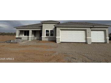 Charming single-story home featuring a spacious two-car garage and desert landscaping at 29577 N 220Th Ave, Wittmann, AZ 85361