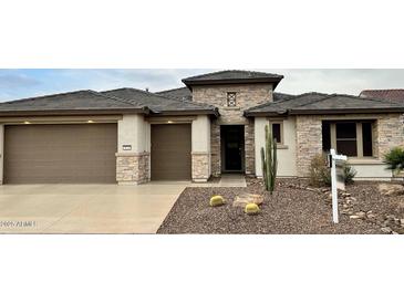 Single-story home with stone accents and a two-car garage at 3020 N 165Th Ave, Goodyear, AZ 85395