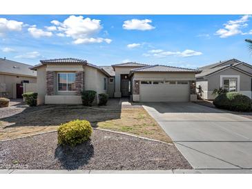 One-story house with stone accents and a two-car garage at 3383 E Santa Fe Ln, Gilbert, AZ 85297