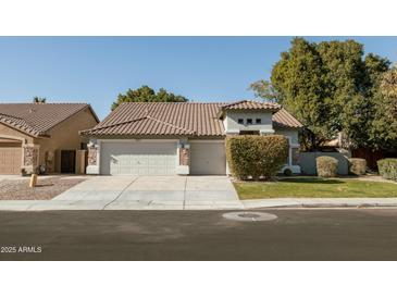 Single-story home with a two-car garage and well-manicured lawn at 3950 S Cactus Wren Dr, Chandler, AZ 85248