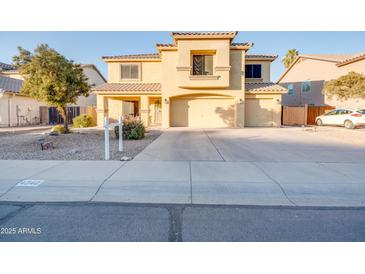 Two-story house with a three-car garage and desert landscaping at 4340 E Silverbell Rd, San Tan Valley, AZ 85143