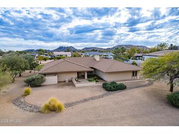 Single-story home with a large yard and mountain views at 4805 W Saguaro Park Ln, Glendale, AZ 85310