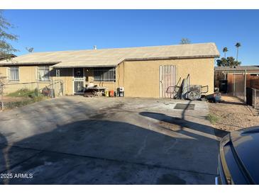 Ranch style home with a large front yard and driveway at 5616 W Granada Rd, Phoenix, AZ 85035