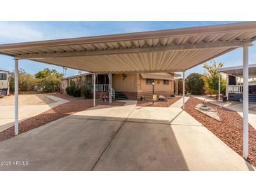 Single-wide manufactured home with carport and landscaping at 6960 W Peoria Ave # 231, Peoria, AZ 85345