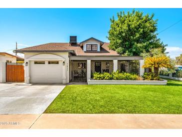 Cute single-story home with a well-manicured lawn and gated driveway at 7837 N 13Th St, Phoenix, AZ 85020