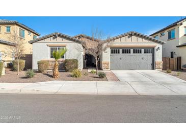 Single-story home with gray garage doors and landscaping at 8513 N 172Nd Ln, Waddell, AZ 85355