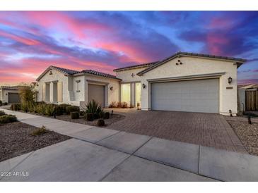 Beautiful home with a two-car garage and landscaped front yard at 10712 E Trillium Ave, Mesa, AZ 85212