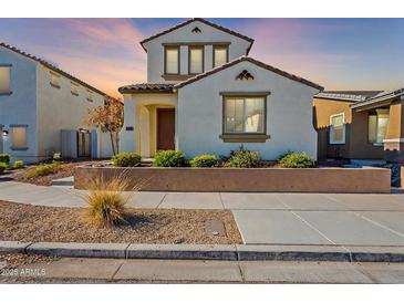 Two-story house with light-colored siding, landscaping, and a walkway at 1080 S 151St Ln, Goodyear, AZ 85338