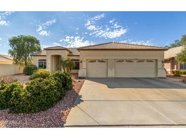 Beautiful single-story home with a two-car garage and well-manicured landscaping at 10949 W Sierra Pinta Dr, Peoria, AZ 85373