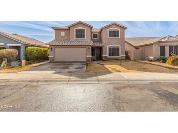 Two-story house with a large garage and landscaped yard at 11163 W Elm Ln, Avondale, AZ 85323