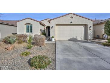 Single-story home with a two-car garage and well-manicured landscaping at 11618 W Levi Dr, Avondale, AZ 85323