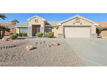 Single-story house with a two-car garage and desert landscaping at 14812 W Las Brizas Ln, Sun City West, AZ 85375