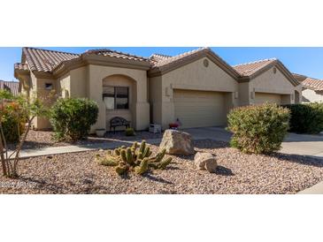 Attractive desert landscape surrounds this charming two-story home with a two-car garage at 1577 E Laurel Dr, Casa Grande, AZ 85122