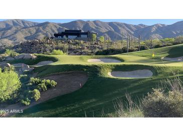 Modern house nestled on a hillside overlooking a golf course at 41104 N 96Th St, Scottsdale, AZ 85262