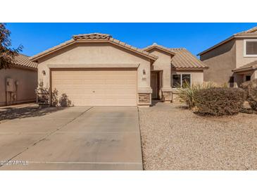 House exterior featuring a two-car garage and well-maintained landscaping at 4572 E Silverbell Rd, San Tan Valley, AZ 85143