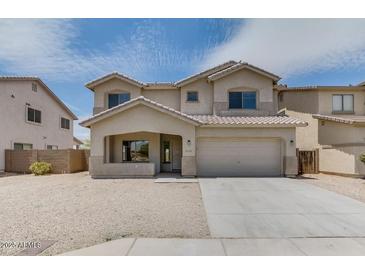 Two story home with a two car garage and desert landscaping at 6102 S 37Th Ln, Phoenix, AZ 85041