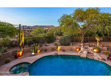 Luxury backyard oasis featuring a sparkling pool, spa, and fire features at 9901 E Hidden Valley Rd, Scottsdale, AZ 85262